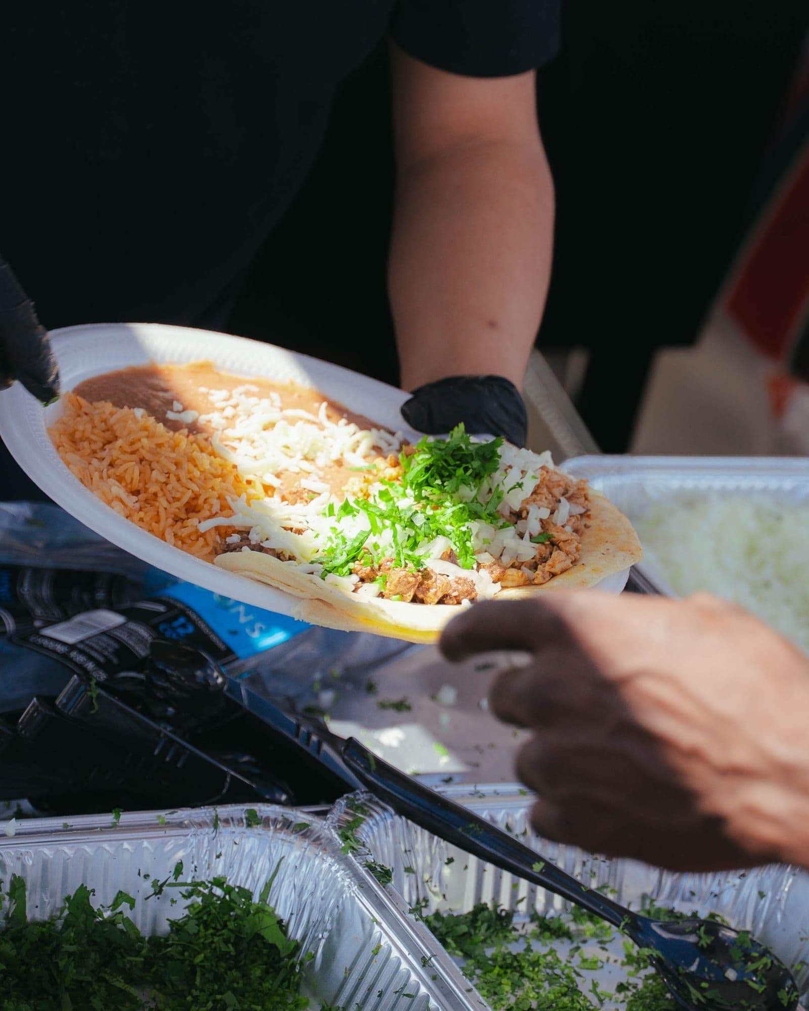 A plate of tacos, rice and beans